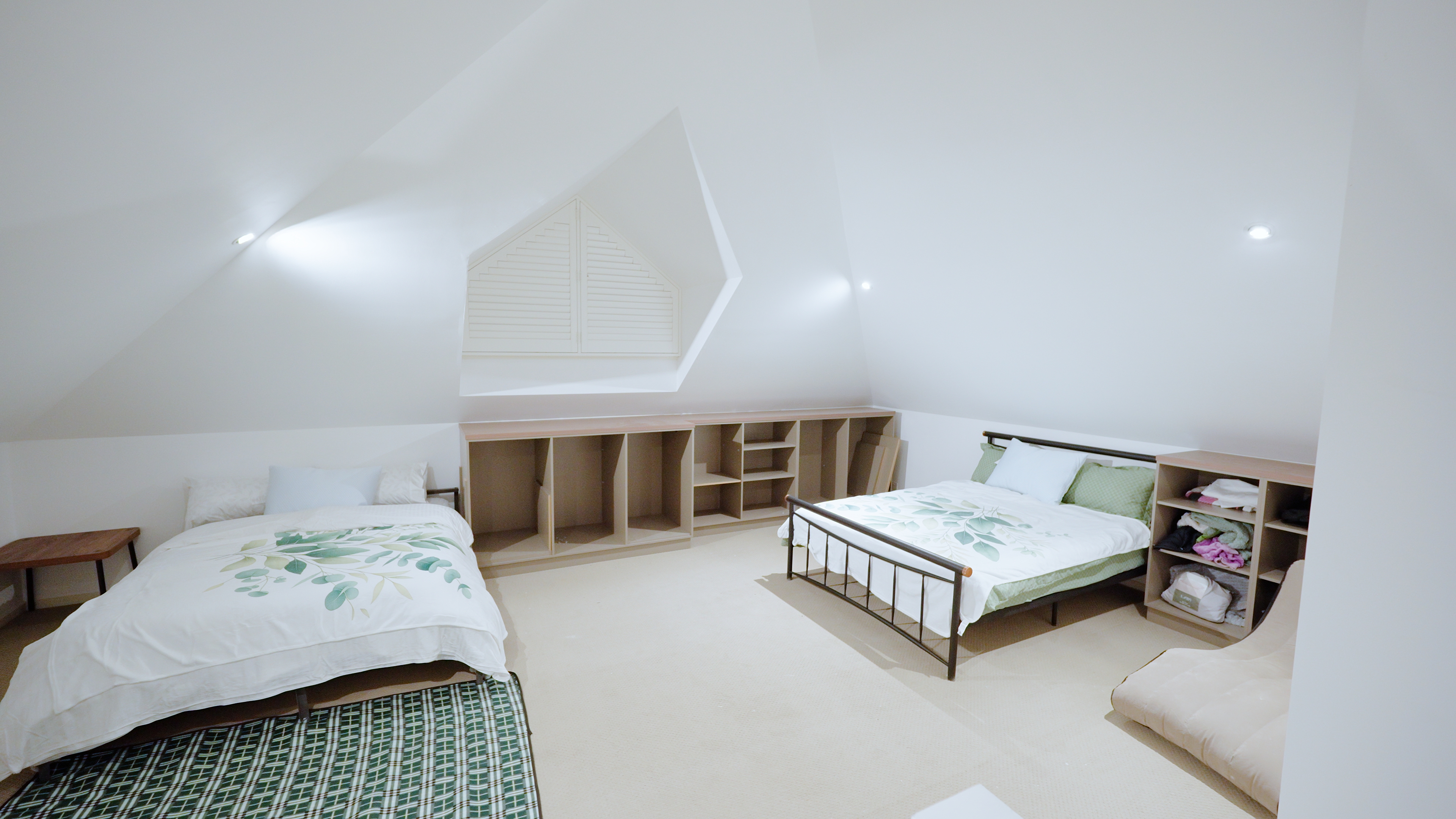 Deluxe loft room with built-in storage and botanical linen