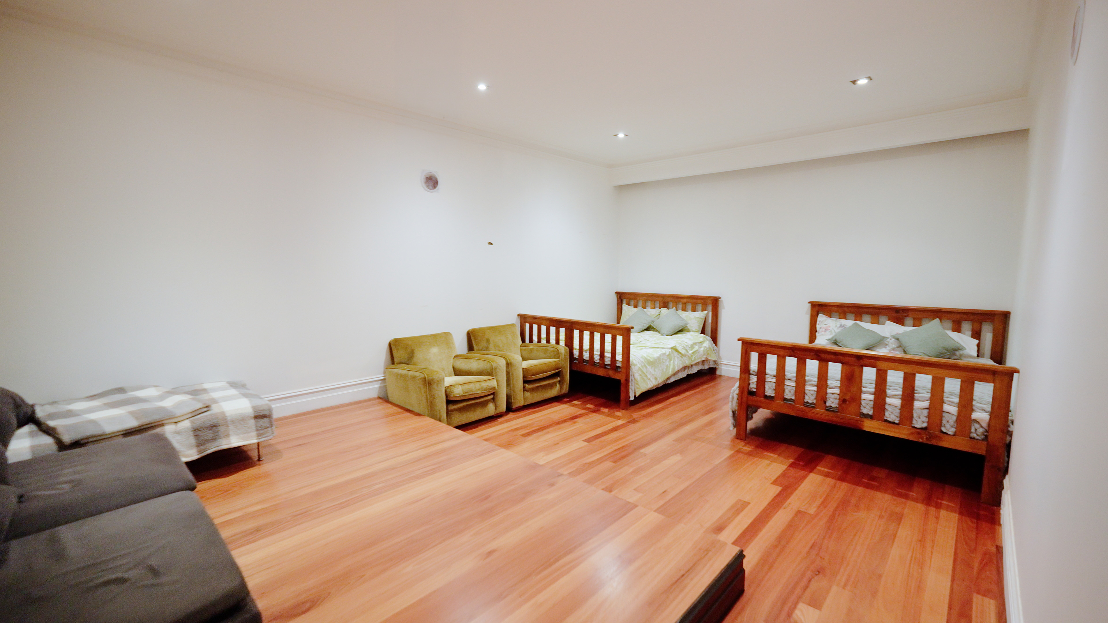 Shared retreat room with timber beds and hardwood floors