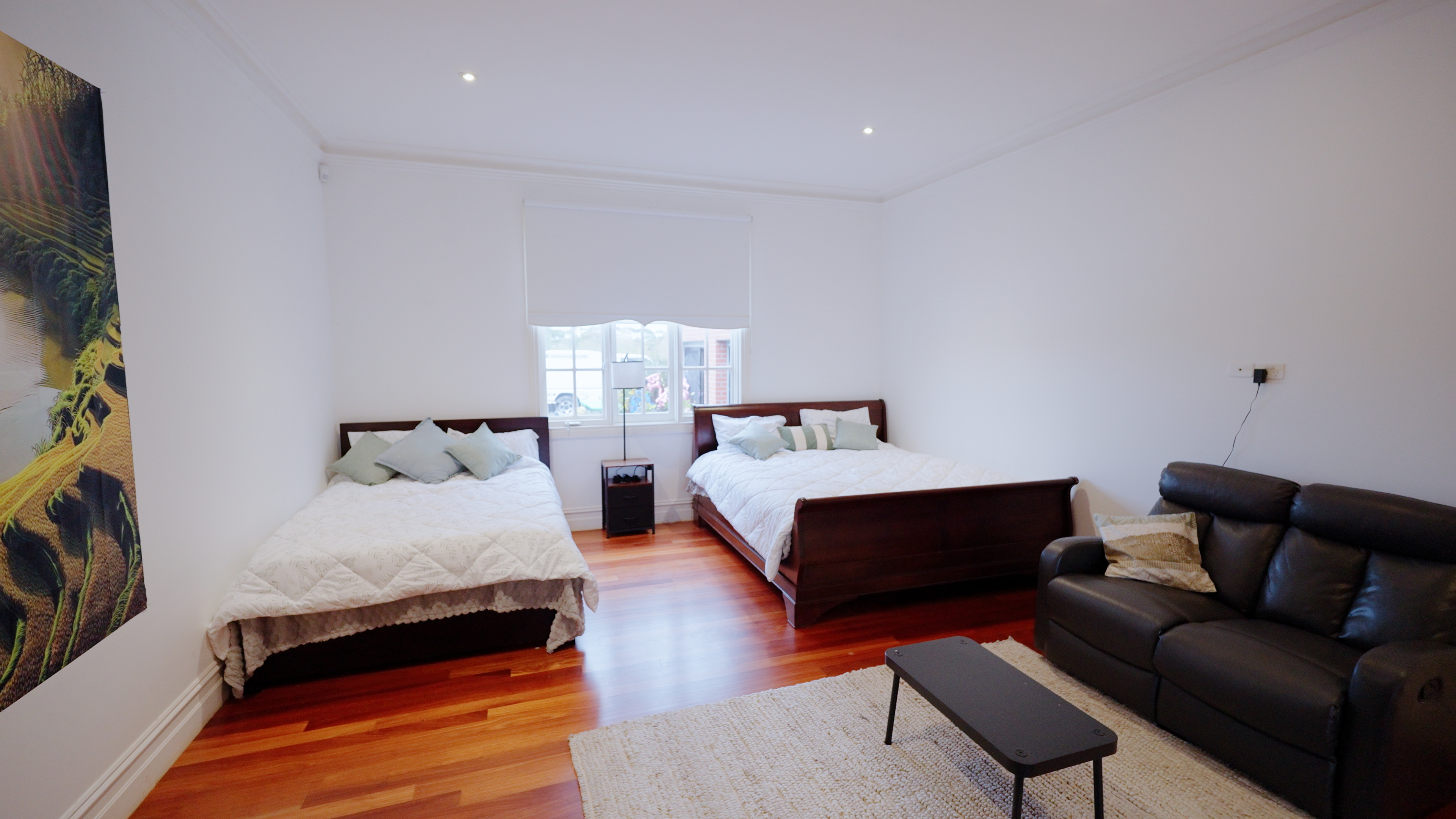 Spacious room with sleigh beds and leather lounge